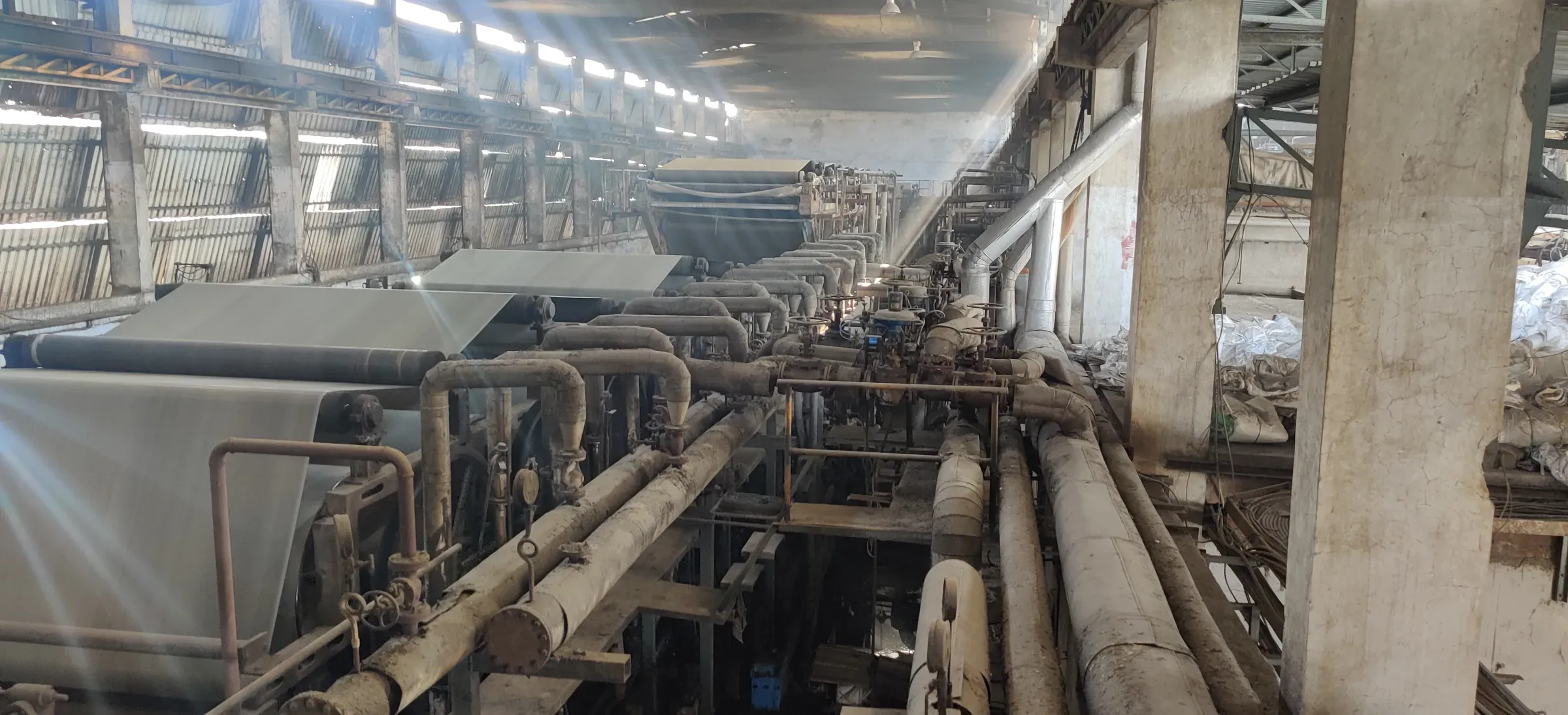 Steam and condensate piping along the dryer section of a paper machine